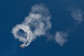 Acrobatic airplane spiraling towards the ground leaving smoke trail behind