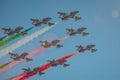 Acrobatic group of Freccia trecolori jet aeroplanes are performing maneouvres in a formation in the italian dolomites close to