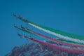 Acrobatic group of Freccia trecolori jet aeroplanes are performing maneouvres in a formation in the italian dolomites close to