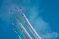 Acrobatic group of Freccia trecolori jet aeroplanes are performing maneouvres in a formation in the italian dolomites close to