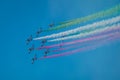 Acrobatic group of Freccia trecolori jet aeroplanes are performing maneouvres in a formation in the italian dolomites close to