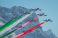 Acrobatic group of Freccia trecolori jet aeroplanes are performing maneouvres in a formation in the italian dolomites close to