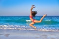 Acrobatic gymnastics bikini girl in a beach Royalty Free Stock Photo