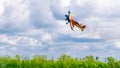An acrobatic plane, flying in the blue sky with white clouds, doing acrobatics Royalty Free Stock Photo