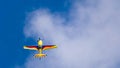 An acrobatic plane, flying in the blue sky with white clouds, doing acrobatics Royalty Free Stock Photo