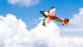 An acrobatic plane, flying in the blue sky with white clouds, doing acrobatics Royalty Free Stock Photo