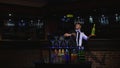 Acrobatic show performed by barman juggling bottle. bar background