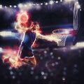 Acrobatic slam dunk of a basket player in the basket at the stadium Royalty Free Stock Photo