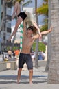 Acrobats practicing gimnastic stunts on a beach in Hollywood, FL Royalty Free Stock Photo