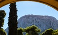 Acrocorinth or Upper Corinth - a monolithic rock overseeing the ancient city of Corinth Greece - viewed through an archway Royalty Free Stock Photo