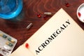 Acromegaly written on book with tablets. Royalty Free Stock Photo