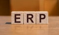 acronym ERP enterprise recource planning text on wooden blocks isolated on yellow background. Business software concept