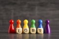 Acronym LGBT written on wooden cubes with pawns in the colors of the rainbow flag