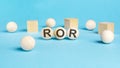 acronym ror on wooden balls, bright blue background