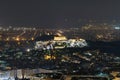 Acropolis in Athens with the city lights as background. Night view. Royalty Free Stock Photo