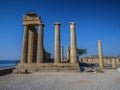 The Acropolis of Lindos in Rhodes, Greece at sunset. Scenic view of Doric columns from the ancient Temple of Athena Lindia setting Royalty Free Stock Photo