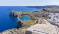 The Acropolis of Lindos in Rhodes island Greece. Saint Paul\'s Beach and Lindos Acropolis aerial panoramic view Royalty Free Stock Photo