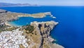 The Acropolis of Lindos in Rhodes island Greece. Saint Paul\'s Beach and Lindos Acropolis aerial panoramic view Royalty Free Stock Photo