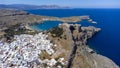 The Acropolis of Lindos in Rhodes island Greece. Saint Paul\'s Beach and Lindos Acropolis aerial panoramic view Royalty Free Stock Photo