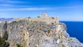 The Acropolis of Lindos in Rhodes island Greece. Saint Paul\'s Beach and Lindos Acropolis aerial panoramic view Royalty Free Stock Photo
