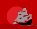 Across the ocean. Old sailing ship. Black silhouette against the red sky. Royalty Free Stock Photo