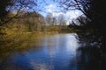 Across the rippled water of a large tree lined lake in winter Royalty Free Stock Photo