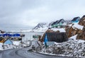 Acrtic road to the docks and port between the rocks with Inuit houses, Sisimiut, Greenland Royalty Free Stock Photo