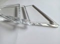 three clear acrylic glass triangles on a white backgroun