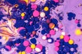 Acrylic paint balls abstract texture. Purple, blue, pink and yellow liquids mix. Creative multicolor background. Bright Royalty Free Stock Photo