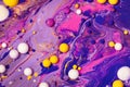 Acrylic paint balls abstract texture. Purple, blue and yellow liquids mix. Creative multicolor background. Bright colors Royalty Free Stock Photo