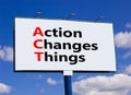 ACT action changes things symbol. Concept words ACT action changes things on big billboard on a beautiful blue sky and clouds Royalty Free Stock Photo
