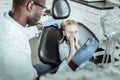 Small blue-eyed girl being afraid of dentist equipment Royalty Free Stock Photo