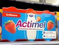 Actimel strawberry yogurt drink packaging on supermarket shelf Royalty Free Stock Photo