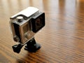Action Cam in Waterproof Camera Housing Case on Wood Desk