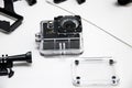 Action camera with accessories on white background top view. Compact gadget waterproof, support 4k video and is often used in extr Royalty Free Stock Photo