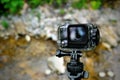 Action camera with aqua box on nature background