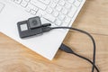 Action-camera connected to a white laptop, against the background of a wooden table Royalty Free Stock Photo