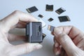 Action camera and microSD memory card in hands on the back of other SD memory cards. Background from gadgets and digital devices Royalty Free Stock Photo