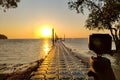 Action camera mounted on a tripod and make a timelapse of the pier and golden sunrise. Focus on the camera Royalty Free Stock Photo