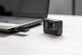 Action camera next to the laptop. Mini SD card inserted in card reader on usb port Royalty Free Stock Photo