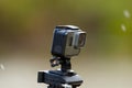 Action camera is recording video on a blurred background of snow and grass. Royalty Free Stock Photo