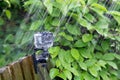 Action camera under heavy rain on nature background