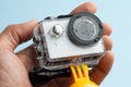 Action camera in a waterproof box and a buoy for diving in drops of water in hand.