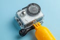 Action camera in a waterproof box and a buoy for diving in water drops on a blue background Royalty Free Stock Photo