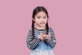 Portrait child school girl on pink background