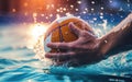 Action close-up of a water polo player hand grabbing the ball over the surface of the water before throwing a shot during a match Royalty Free Stock Photo