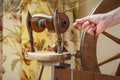 Action Detail of hands working old Fashioned Wool Spinning Wheel. Royalty Free Stock Photo