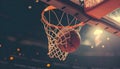 An action photo of a basketball going through the basket of a live game