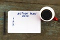`Action plan` text on paper, with cup of coffee and pen on the wooden table - business and finance concept Royalty Free Stock Photo