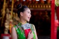 Action portrait beautiful Asian girl wearing Cheongsam red dress. Royalty Free Stock Photo